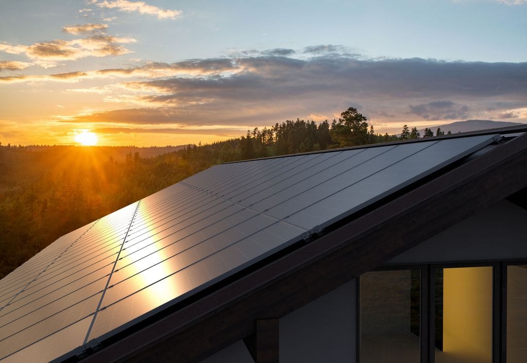 House with solar panels sunrise